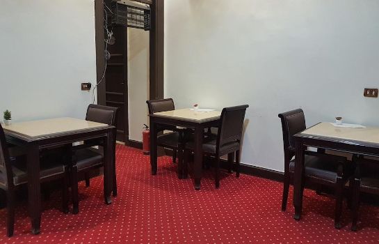 Cairo Paradise Hotel In Alqam Hotel De Gentles busy preparing akee and codfish, a seafood dish enhanced by.